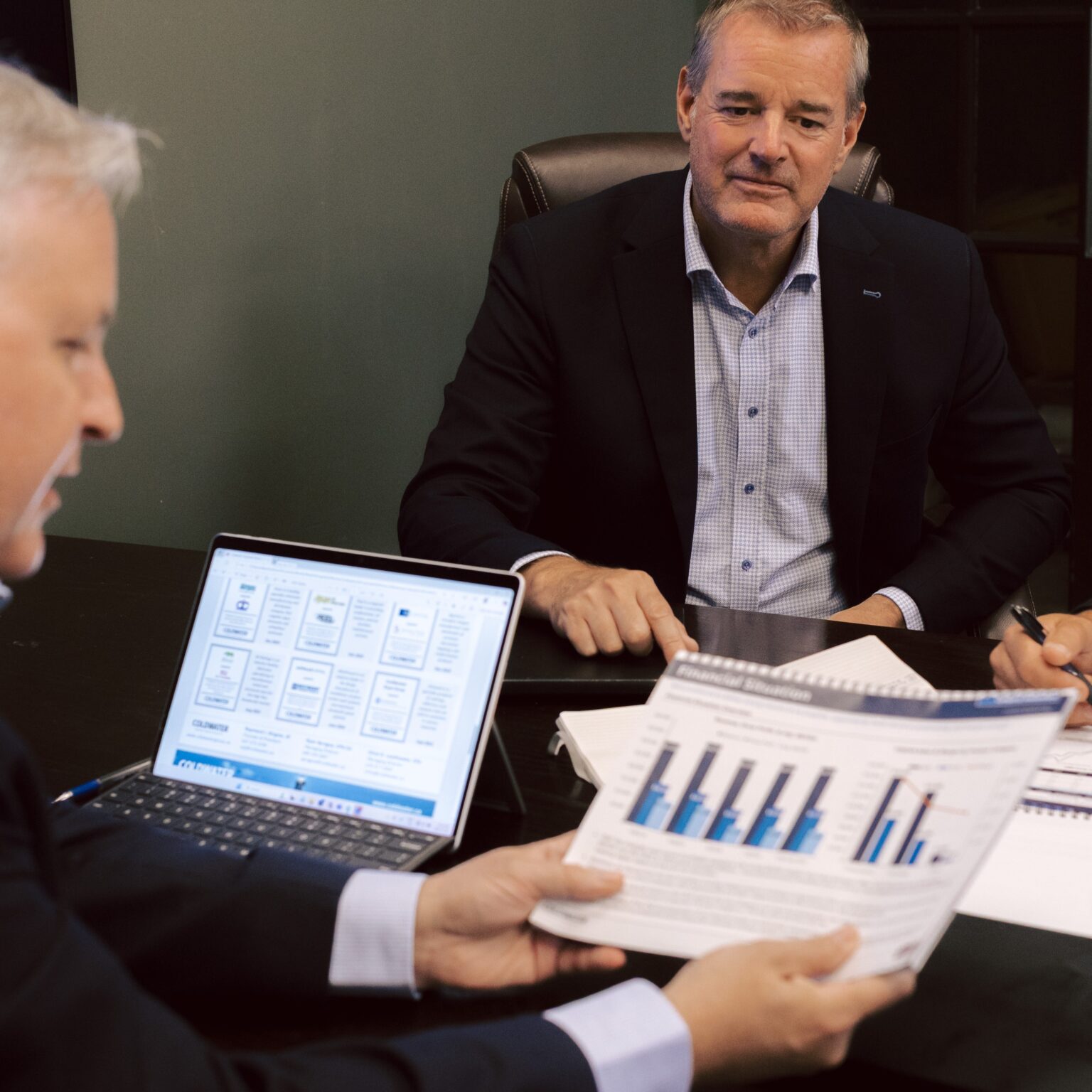 business professionals discussing mergers and acquisitions strategy